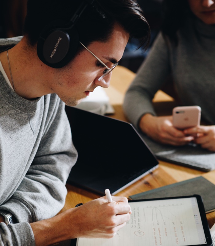 College student studying for his next exam in a coffee shop